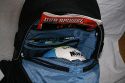CRUMPLER OPULENT ROOSTER\n\nFoto von Susanne Krischke - VIELEN DANK FR DEIN MAIL!\n\nKommentar des Nutzers:\n\nHier ist er, mein Opulent Rooster von Crumpler:\nhttp://www.crumpler.de/?page=details&product_line=578\n\nAussenmass (cm): 36x53x24\nPhotofach (cm): 34x19x18 (Gehuse, bis 4 Objektive)\nLaptopfach (cm): 34x28x4 (bis 17"W)\n\nIch wollte einen Rucksack den ich u.a. als Handgepck fr Flugreisen benutzen kann in dem Laptop, Fotoausrstung und weiterer Kleinkram Platz findet. Ich bevorzuge Designs, die nicht sofort als Foto-/Laptoptasche erkannt werden. Irgendwie stie ich da auf Crumpler. \n\nDie extrem gute, solide Verarbeitung fhlt sich spitze an und der Rucksack glnzt mit vielen Extrafchern und tollen Detaillsungen. Die ffnungen der einzelnen Fcher sind nicht sehr auffllig, was ein unaufflliges-aus-der-Tasche-klauen erschweren drfte. Das angenehme Tragesystem kann durch einen Hftgurt mit Dokumentenfach erweitert werden (nicht mitgeliefert). Hinter dem gut gepolsterte Rckenteil verbirgt sich ein Laptopfach. \n\nDas Hauptfach ist gro: als Demo habe ich einen Volleyball reingesteckt, eine DVD in eine der zahlreichen Innentaschen. Das hintere Fach ist flach, ein DIN A4 Magazin geht nicht rein (Laptopfach), wohl aber Dokumente. Ein weiteres fast unsichtbares Fach entdeckt man, wenn man einen Reiverschlu ber dem Fotofach ffnet: man klappt den Teil hoch und findet ettliche Innentaschen mit reichlich Platz fr Kleinkram wie Filter, Kabel, Speicherkarten usw. \n\nGagig: ein sehr kleines Fach befindet sich in der seitlichen Polsterung des Tragegurtes, gro genug fr einen kleinen Mp3-Player, Kopfhrerschlaufen sind am Trageriemen vorhanden. (Bild OR_009)\n\nDas Fotofach ist ganz unten, abgetrennt vom oberen Teil durch eine Trennwand, die bei Bedarf per Reisverschlu geffnet werden kann. Die Polsterung fr das Fotoequipment kann man entfernen und somit den Rucksack auch fr andere Aktivitten nutzen. Ohne der Fotofcher mit geffneter Trennwand geht z.B. auch der Lowe Slingshot AW200 in den Opulent Rooster (Bild OR_010) - dann kann man also auch im Urlaub den genialen Slingshot verwenden und hat immer noch Platz fr andere Sachen im Rucksack.\n\nMeine Ladung: Laptop 14"; Canon EOS 400D; Canon Objektive 10-22, 17-85 mit Geli, 70-300; Kleinkram. Ich habe kein weies Monsterobjektiv, als Grendemo habe ich ein 1 Liter Tetrapack in die Tasche gepackt. Mit weiem Riesen pat allerdings kein Objektiv an die Kamera. Das Hauptfach ist dann noch leer.