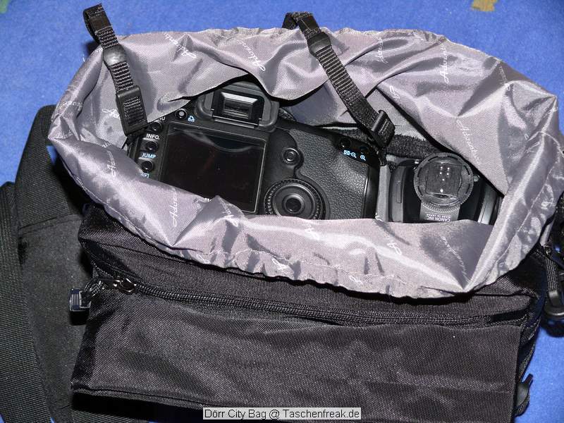 Drr City Bag\n\nFoto von Jrg Langer\n\nKommentar des Nutzers:\n\nEine kleine Fototasche die nicht nach Fototasche aussieht und genau damit wird sie m.E. Ihrem Namen "City Bag" sehr gerecht.\n\nEs passen in dieses kleine Packwunder gut rein:\n\n- eine DSLR mit einem relativ groen Standardzoom wie einem 28-300er oder einem 18-200er oder hnlichen Formfaktoren. Ein Canon 24-70 2,8L ist etwa 1 cm zu lang. In unserem "Packbeispiel hier haben wir ein 12-24 mit 82er Filterdurchmesser verwendet was deutlich grer ist als eins der genannten Reisezooms.\n\n- dazu eine 50er Festbrennweite und einen groen Systemblitz und Akkus dazu.\n\n- In die vielen kleinen und greren Reisverschluss und Kletttaschen passen dann gut, Geldbrse, PDA, Handy und CF Cards sowie anderer Kleinkram rein.\n\nDier Tasche lsst sich sehr angenehm als Schulter- oder auch Torsotasche tragen.\n\nDer Preis ist mit 35 Euro vergleichsweise gnstig und dadurch ist die Drr City Bag auch gut als "Zweittasche" haltbar.\n\nDie Verarbeitung ist sehr hochwertig und sehr robust.\n\nDie Innentasche wird mit einem Kordelverschluss verzogen/verschlossen und dadurch ist die Cam auch relativ "Wasserfest" untergebracht.\n\nLeider passt auch das Equipment der Frau wie auf 2 Bildern zu sehen hervorragend hier rein, was den Innerfamiliren Konflikt "wer nutzt welche Tasche" nicht einfacher macht ;-)\n\nTaschenfreak Empfehlung: Sehr empfehlenswert!!!!
