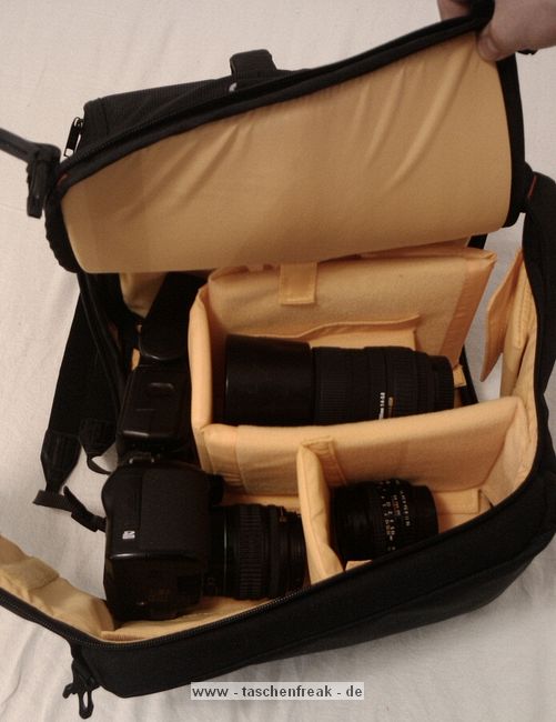 KATA 3N1-33\n\nFoto und Text von Lars Andresen - VIELEN DANK!\n\nKommentar:\n\nFotorucksack Kata 3N1-33 mit Daypack, Kamerafach und Laptopfach + Stativhalter STH-3N1\n\nDer 3n1-33 entspricht weitestgehend dem 3n1-30, als groe Neuerung ist ein Laptopfach hinzugekommen.\n\nDa dies mein erster Fotorucksack ist, habe ich leider keinen wirklichen Vergleich,\naber ich will dennoch mal versuchen hier einen berblick ber die Tasche zu geben.\n\nWas alles dabei war lsst sich auf dem ersten Bild recht gut erkennen:\nDer Rucksack, der Stativhalter und die obere Befestigungsschlaufe, \n2 groe Trennwnde, 5 kleine Trennwnde, der Regenschutz und die Speicherkartentasche.\n -Die beiden groen Trennwnde sind spiegelverkehrt, \n   d.h. es ist eine exakt spiegelverkehrte Einteilung des Rucksacks mglich.\n -Die kleinen Trennwnde sind alle gleich.\n -Der Regenschutz ist sich selbst seine Tasche.\n -Und die Speicherkartentasche hat Klettband an der Rckseite, \n   lsst sich also an vielen Stellen befestigen.\n\n\n### Tragesystem\n\nDas interessante an der Tasche ist ja das Tragesystem, wer mal nach der Tasche gegoogelt hat wird wissen warum.\nMan kann die Trger auf mehre Art- und Weisen verwenden:\n1. Wie einen normalen Rucksack.\n2. Im Sling mit entweder dem rechten oder dem linken Trger, je nach Belieben\n3. Mit den Trgern ber Kreuz, was in einem sehr festen Sitz des Rucksacks resultiert\n\n -Zu jeder Konfiguration kann man noch den eingebauten Beckengurt verwenden, womit sich der Rucksack dann endgltig nicht mehr bewegt ;-)\n -Nicht gebrauchte Trger lassen sich bequem hinter einer Polsterungsschicht wegklappen, das geht auch mit allen gleichzeitig.\n -Fr die, die es haben wollen: es gibt eine Lasche um den Rucksack auf einen Trolley zu stecken, \n	hier ist dann wohl das weg packen aller Trger ziemlich hilfreich.\n -Die Schnallen lassen sich sehr leichtgngig verstellen, wenn man sie senkrecht zur Gurtrichtung hlt.\n	Ebenso funktioniert das "Ziehen am Gurtende" zum Feststellen an allen Trgern problemlos.\n	Dafr halten die Schnallen in Normalposition wie eine 1, da rutsch nichts an Gurt wieder zurck, genau wie es sein soll.*\n -Unbenutzter Restgurt kann ein wenig verstaut werden:\n	Auf den Trgergurten gibt es zwei frei verschiebliche Gurtumschlieende Teile, in die mal die Gurte zurckschieben kann.\n	Fr die Beckengurte gibt es sowas nicht direkt sondern zur zwei Gummizugringe um die Gurte,\n	da stren lose Gurte aber auch bei weitem nicht so sehr, wie an den Trgern\n -Der beste Sitz ist aus meiner Sicht definitiv mit den Trgern ber Kreuz (+optional Beckengurt):\n	Die Tasche hat dort einfach den besten Halt. Die Armfreiheit wird nicht beeintrchtigt, \n	und die Tasche scheint auch genau darauf ausgelegt zu sein.\n	Es kann zudem schnell in den Sling gewechselt werden indem man einfach einen der beiden Trger lst\n\n*Ein Test war: Den Rucksack mit etwa 8 kg Gewicht an einer einzigen Schnalle festgehalten und hochgezogen: Es rutschte kein Gurt nach.\n\n\n### Laptopfach\n\nEin wenig gro fr meinen 13-Zller, aber in den 3n1-22 htte er nicht mehr reingepasst.\nKata liefert die Werte 42*27*4 (H*B*T), die ich soweit auch (als Maximalwerte) besttigen kann.\nAm Boden des Laptopfachs ist ein 2x3 cm Schaumstoffstreifen, der wohl das meiste abfedern drfte.\nZum Rcken hin gibt es drei Schichten:\nEinmal die Rckwand, dann eventuelle verstaute Trger und dann noch einmal die normale Rckenpolsterung.\nMeines Erachtens kann da soweit erstmal nichts durchkommen\nNur die Reiverschlsse knnten an den Seiten ein wenig weiter runtergehen.\n\n\n### Daypack\n\nEs lsst sich sehr weit ffnen, mit zwei etwas schwergngigeren Reiverschlssen (gehen halt um die Rundungen).\nDie beiden Seitentaschen haben jeweils nochmal eine recht unbedeutende einfache Netzunterteilung und teilen sich mit dem Daypack das Fach,\nhaben aber auch nicht sonderlich viel Stauraum, ein normalgroes Protemonnaie wrde wohl noch rein passen.\nDas Daypack ist recht gro, zwei 1,5l Eisteepackungen passen locker rein.\n\nIch hab einfach mal alles reingeschmissen was mir eingefallen ist, was man mitnehmen knnte:\nLadegert, Notizbuch, Portemonnaie, HTC Hero, Polfilter, Lenspen, Taschenlampe, \nLaptopnetzteil, Ministativ, Maus fr Laptop, Regenschutz.\nIn Netztasche: 2*4 Eneloops\nIn Seitentaschen: Selbstbau-Kabelauslser, Nahlinse in Case, MP3-Player, Raynox 250.\nUnd es war immernoch massig Platz. Mindestens eine Eisteepackung...\n\n\n### Kamerafach\n\nDie Unterteilung zwischen Kamerafach und Daypack erfolgt ber einen Zwischenboden, \nder sich dank eines Reiverschlusses auch in Richtung Laptopfach wegklappen lsst.\nVon daher kann man im Notfall auch mal berma transportieren.\nDas Fach selbst lsst sich wie gewohnt recht vielseitig einteilen.\nDie Mae des Fachs betragen 30*29,5*16 cm (HxBxT), es passt also auch mal etwas unfrmigeres rein.\n\nDas ganze Kamerafach wird von einem einzigen Reiverschluss verschlossen, auf diesem sind jedoch gleich 4 Schieber.\nJe zwei der Schieber befinden sich (im geschlossenen Zustand) an je einer der beiden groen Schnallen.\nZieht man die Tasche im Sling nach vorne, bspw. als Rechtshnder ber die linke Seite, \ndann kann man mit der linken Hand die Schnalle lsen und mit der anderen, mit einem Zug an der Schnalle, den Seiteneingriff aufziehen.\nDer Eingriff in das Kamerafach kann sich im Gebrauch auf die Seiteneingriffe beschrnken. \nDiese sind ausreichend gro dimensioniert, so dass man bei Zugriff von beiden Seiten an das ganze Fach ran kommt.\nNatrlich kann man das Fach auch komplett ffnen, wenn man z.b. die Trennwnde neu verstellen will.\nEine interessante Zusatzmglichkeit bieten die beiden groen Seitenwnde, diese haben an einem Ende jeweils eine Klappe, \ndie sich mit einem kleinen Klettpunkt verschlieen lsst. \n\nMglichkeiten um die Trennwnde zu befestigen finden sich am Boden und am Zwischenboden zum Daypack, \nzudem ziehen sich zwei Klettbnder ber die Rckwand (zum Laptopfach), sowie ber die beiden Seitenwnde.\nErscheint auf der ersten Blick eher wenig, aber da die Trennwnde ja selbst wieder neue Befestigungsmglichkeiten darstellen, \nvermisse ich eigentlich nichts.\nDie "Auenwand" hat lediglich zwei Befestigungslaschen im oberen Bereich fr eine Trennwand, am besten auf den Bildern angucken.\nDa die groen Seitenwnde genau gespiegelt vorliegen ist eine exakt spiegelverkehrte Einteilung des Fachs mglich.\n\nBei den Fotos ist jetzt ein Einteilungsversuch von mir mit drin, der sich spter jedoch als unpraktikabel herausgestellt hat.\n(Die Kamera passt in der Position nicht mit montiertem Blitz durch den Seiteneingriff)\n\n\n### Stativhalter\n\nZunchst zu den entsprechenden Bildern: \nAls ich die ersten Bilder geschossen hatte, war das Manfrotto 190XPROB mit 486RC2 noch nicht da, \ndaher ist auf einigen Bildern noch das minimal unpraktischere Sony Elevator zu sehen.\n\nDer Stativhalter ist standardmig nicht im Lieferumfang und kostet je nach Shop ~13 bis 20.\nDie ich keinen anderen Rucksack mit Stativhalter habe kann ich schlecht vergeichen, halte ihn aber fr recht brauchbar.\n\nDie Befestigung erfolgt ber drei Punkte, mit Klettband am D-Ring in der Mitte der Tasche, \nsowie mit zwei kleinen Gurten an den beiden Sicherungsschnallen am unteren Ende.\nDazu gibt es einen Befestigungsschlaufe, die das Stativ oben rum befestigt, diese wird mit einem Klettband an dem Handgriff \ndes Rucksacks befestigt, ist lngenverstellbar (Klett) und schliet mit einer Schnalle.\n\nIch befrchtete erst, dass das 190er zu gro sein wird, aber es scheint noch gerade so zu passen.\n\nDie Befestigungsschlaufe hlt das Stativ recht gut fest, auch ber Kopf (zumindest so, wie ich es befestigt habe).\n\nDie Grenangaben fr den Halter sind:\nHead Base Perimeter: 29 cm\nLeg Perimeter: 30 cm\nHeight: 48 cm (bezieht sich wohl auf die Hhe der Stativbeine)\nMax Tripod weight: 2 kg\n\nVerglichen mit dem 190er:\nDurchmesser an der Basis: 30 cm, wobei ich das Stativ nicht an der Stelle des grten Durchmessers befestige, von daher egal.\nBeindurchmesser: 29 cm (Maband um die dickste Stelle, also um die Befestigungshebel) -> passt\nHhe: Beinlnge 50 cm, bis zum Kopf 57 cm, mit Kopf: 65 cm -> passt\nGewicht: Mit Kugelkopf wiegt das 190er 2,2 kg, also leicht drber -> passt\n\nAuch wenn das Stativ durch die Befestigung am Handgriff ein bisschen nach links und rechts schwingen kann, \nkonnte ich beim tragen bis jetzt keine nennenswerten Einschrnkungen feststellen. \nLediglich im Sling, wenn man den Rucksack wieder auf den Rcken ziehen will \nmacht sich das zustzliche Gewicht so weit auen bemerkbar.