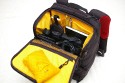 KATA 3N1-33\n\nFoto und Text von Lars Andresen - VIELEN DANK!\n\nKommentar:\n\nFotorucksack Kata 3N1-33 mit Daypack, Kamerafach und Laptopfach + Stativhalter STH-3N1\n\nDer 3n1-33 entspricht weitestgehend dem 3n1-30, als groe Neuerung ist ein Laptopfach hinzugekommen.\n\nDa dies mein erster Fotorucksack ist, habe ich leider keinen wirklichen Vergleich,\naber ich will dennoch mal versuchen hier einen berblick ber die Tasche zu geben.\n\nWas alles dabei war lsst sich auf dem ersten Bild recht gut erkennen:\nDer Rucksack, der Stativhalter und die obere Befestigungsschlaufe, \n2 groe Trennwnde, 5 kleine Trennwnde, der Regenschutz und die Speicherkartentasche.\n -Die beiden groen Trennwnde sind spiegelverkehrt, \n   d.h. es ist eine exakt spiegelverkehrte Einteilung des Rucksacks mglich.\n -Die kleinen Trennwnde sind alle gleich.\n -Der Regenschutz ist sich selbst seine Tasche.\n -Und die Speicherkartentasche hat Klettband an der Rckseite, \n   lsst sich also an vielen Stellen befestigen.\n\n\n### Tragesystem\n\nDas interessante an der Tasche ist ja das Tragesystem, wer mal nach der Tasche gegoogelt hat wird wissen warum.\nMan kann die Trger auf mehre Art- und Weisen verwenden:\n1. Wie einen normalen Rucksack.\n2. Im Sling mit entweder dem rechten oder dem linken Trger, je nach Belieben\n3. Mit den Trgern ber Kreuz, was in einem sehr festen Sitz des Rucksacks resultiert\n\n -Zu jeder Konfiguration kann man noch den eingebauten Beckengurt verwenden, womit sich der Rucksack dann endgltig nicht mehr bewegt ;-)\n -Nicht gebrauchte Trger lassen sich bequem hinter einer Polsterungsschicht wegklappen, das geht auch mit allen gleichzeitig.\n -Fr die, die es haben wollen: es gibt eine Lasche um den Rucksack auf einen Trolley zu stecken, \n	hier ist dann wohl das weg packen aller Trger ziemlich hilfreich.\n -Die Schnallen lassen sich sehr leichtgngig verstellen, wenn man sie senkrecht zur Gurtrichtung hlt.\n	Ebenso funktioniert das "Ziehen am Gurtende" zum Feststellen an allen Trgern problemlos.\n	Dafr halten die Schnallen in Normalposition wie eine 1, da rutsch nichts an Gurt wieder zurck, genau wie es sein soll.*\n -Unbenutzter Restgurt kann ein wenig verstaut werden:\n	Auf den Trgergurten gibt es zwei frei verschiebliche Gurtumschlieende Teile, in die mal die Gurte zurckschieben kann.\n	Fr die Beckengurte gibt es sowas nicht direkt sondern zur zwei Gummizugringe um die Gurte,\n	da stren lose Gurte aber auch bei weitem nicht so sehr, wie an den Trgern\n -Der beste Sitz ist aus meiner Sicht definitiv mit den Trgern ber Kreuz (+optional Beckengurt):\n	Die Tasche hat dort einfach den besten Halt. Die Armfreiheit wird nicht beeintrchtigt, \n	und die Tasche scheint auch genau darauf ausgelegt zu sein.\n	Es kann zudem schnell in den Sling gewechselt werden indem man einfach einen der beiden Trger lst\n\n*Ein Test war: Den Rucksack mit etwa 8 kg Gewicht an einer einzigen Schnalle festgehalten und hochgezogen: Es rutschte kein Gurt nach.\n\n\n### Laptopfach\n\nEin wenig gro fr meinen 13-Zller, aber in den 3n1-22 htte er nicht mehr reingepasst.\nKata liefert die Werte 42*27*4 (H*B*T), die ich soweit auch (als Maximalwerte) besttigen kann.\nAm Boden des Laptopfachs ist ein 2x3 cm Schaumstoffstreifen, der wohl das meiste abfedern drfte.\nZum Rcken hin gibt es drei Schichten:\nEinmal die Rckwand, dann eventuelle verstaute Trger und dann noch einmal die normale Rckenpolsterung.\nMeines Erachtens kann da soweit erstmal nichts durchkommen\nNur die Reiverschlsse knnten an den Seiten ein wenig weiter runtergehen.\n\n\n### Daypack\n\nEs lsst sich sehr weit ffnen, mit zwei etwas schwergngigeren Reiverschlssen (gehen halt um die Rundungen).\nDie beiden Seitentaschen haben jeweils nochmal eine recht unbedeutende einfache Netzunterteilung und teilen sich mit dem Daypack das Fach,\nhaben aber auch nicht sonderlich viel Stauraum, ein normalgroes Protemonnaie wrde wohl noch rein passen.\nDas Daypack ist recht gro, zwei 1,5l Eisteepackungen passen locker rein.\n\nIch hab einfach mal alles reingeschmissen was mir eingefallen ist, was man mitnehmen knnte:\nLadegert, Notizbuch, Portemonnaie, HTC Hero, Polfilter, Lenspen, Taschenlampe, \nLaptopnetzteil, Ministativ, Maus fr Laptop, Regenschutz.\nIn Netztasche: 2*4 Eneloops\nIn Seitentaschen: Selbstbau-Kabelauslser, Nahlinse in Case, MP3-Player, Raynox 250.\nUnd es war immernoch massig Platz. Mindestens eine Eisteepackung...\n\n\n### Kamerafach\n\nDie Unterteilung zwischen Kamerafach und Daypack erfolgt ber einen Zwischenboden, \nder sich dank eines Reiverschlusses auch in Richtung Laptopfach wegklappen lsst.\nVon daher kann man im Notfall auch mal berma transportieren.\nDas Fach selbst lsst sich wie gewohnt recht vielseitig einteilen.\nDie Mae des Fachs betragen 30*29,5*16 cm (HxBxT), es passt also auch mal etwas unfrmigeres rein.\n\nDas ganze Kamerafach wird von einem einzigen Reiverschluss verschlossen, auf diesem sind jedoch gleich 4 Schieber.\nJe zwei der Schieber befinden sich (im geschlossenen Zustand) an je einer der beiden groen Schnallen.\nZieht man die Tasche im Sling nach vorne, bspw. als Rechtshnder ber die linke Seite, \ndann kann man mit der linken Hand die Schnalle lsen und mit der anderen, mit einem Zug an der Schnalle, den Seiteneingriff aufziehen.\nDer Eingriff in das Kamerafach kann sich im Gebrauch auf die Seiteneingriffe beschrnken. \nDiese sind ausreichend gro dimensioniert, so dass man bei Zugriff von beiden Seiten an das ganze Fach ran kommt.\nNatrlich kann man das Fach auch komplett ffnen, wenn man z.b. die Trennwnde neu verstellen will.\nEine interessante Zusatzmglichkeit bieten die beiden groen Seitenwnde, diese haben an einem Ende jeweils eine Klappe, \ndie sich mit einem kleinen Klettpunkt verschlieen lsst. \n\nMglichkeiten um die Trennwnde zu befestigen finden sich am Boden und am Zwischenboden zum Daypack, \nzudem ziehen sich zwei Klettbnder ber die Rckwand (zum Laptopfach), sowie ber die beiden Seitenwnde.\nErscheint auf der ersten Blick eher wenig, aber da die Trennwnde ja selbst wieder neue Befestigungsmglichkeiten darstellen, \nvermisse ich eigentlich nichts.\nDie "Auenwand" hat lediglich zwei Befestigungslaschen im oberen Bereich fr eine Trennwand, am besten auf den Bildern angucken.\nDa die groen Seitenwnde genau gespiegelt vorliegen ist eine exakt spiegelverkehrte Einteilung des Fachs mglich.\n\nBei den Fotos ist jetzt ein Einteilungsversuch von mir mit drin, der sich spter jedoch als unpraktikabel herausgestellt hat.\n(Die Kamera passt in der Position nicht mit montiertem Blitz durch den Seiteneingriff)\n\n\n### Stativhalter\n\nZunchst zu den entsprechenden Bildern: \nAls ich die ersten Bilder geschossen hatte, war das Manfrotto 190XPROB mit 486RC2 noch nicht da, \ndaher ist auf einigen Bildern noch das minimal unpraktischere Sony Elevator zu sehen.\n\nDer Stativhalter ist standardmig nicht im Lieferumfang und kostet je nach Shop ~13 bis 20.\nDie ich keinen anderen Rucksack mit Stativhalter habe kann ich schlecht vergeichen, halte ihn aber fr recht brauchbar.\n\nDie Befestigung erfolgt ber drei Punkte, mit Klettband am D-Ring in der Mitte der Tasche, \nsowie mit zwei kleinen Gurten an den beiden Sicherungsschnallen am unteren Ende.\nDazu gibt es einen Befestigungsschlaufe, die das Stativ oben rum befestigt, diese wird mit einem Klettband an dem Handgriff \ndes Rucksacks befestigt, ist lngenverstellbar (Klett) und schliet mit einer Schnalle.\n\nIch befrchtete erst, dass das 190er zu gro sein wird, aber es scheint noch gerade so zu passen.\n\nDie Befestigungsschlaufe hlt das Stativ recht gut fest, auch ber Kopf (zumindest so, wie ich es befestigt habe).\n\nDie Grenangaben fr den Halter sind:\nHead Base Perimeter: 29 cm\nLeg Perimeter: 30 cm\nHeight: 48 cm (bezieht sich wohl auf die Hhe der Stativbeine)\nMax Tripod weight: 2 kg\n\nVerglichen mit dem 190er:\nDurchmesser an der Basis: 30 cm, wobei ich das Stativ nicht an der Stelle des grten Durchmessers befestige, von daher egal.\nBeindurchmesser: 29 cm (Maband um die dickste Stelle, also um die Befestigungshebel) -> passt\nHhe: Beinlnge 50 cm, bis zum Kopf 57 cm, mit Kopf: 65 cm -> passt\nGewicht: Mit Kugelkopf wiegt das 190er 2,2 kg, also leicht drber -> passt\n\nAuch wenn das Stativ durch die Befestigung am Handgriff ein bisschen nach links und rechts schwingen kann, \nkonnte ich beim tragen bis jetzt keine nennenswerten Einschrnkungen feststellen. \nLediglich im Sling, wenn man den Rucksack wieder auf den Rcken ziehen will \nmacht sich das zustzliche Gewicht so weit auen bemerkbar.