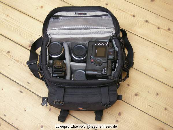 Foto von Ralf Neumann - VIELEN DANK!\n\nKommentar des Nutzers:\n\nLowepro Elite AW\nSehr robuste Tasche fr die kleinere Ausrstung. DSLR mit 4 Objektiven plus Blitz passt prima (meine Sigma SD10 passt auch mit angesetztem Batteriefach wenn ich in die mittleren Fcher kurze Objektive packe).\nWenn die Tasche einen Nachteil hat, ist es die Unterteilung der Vordertasche, die dadurch doch recht eng wird. Viele empfinden dies anders, ich bin jedoch kein Freund von vielen kleinen Fchern. AW steht bei Lowepro fr eine Art Regencape, das in dem rckwrtigen Fach untergebracht ist. Der Deckel lappt ber und schtzt auch ohne das Regencape gut vor Feuchtigkeit. Recht hoher Preis, der jedoch meiner Meinung nach durch die Verarbeitung gerechtfertigt ist. S&F Zubehr kann an den Seiten angesetzt werden.