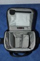 LOWEPRO - TOP LOADER ZOOM AW\n\nFoto von Peter Albrecht - VIELEN DANK!\n\nKommentar:\n\n- gekauft Januar 2009 (scheint auch berarbeitete Version zu sein gegenber dem Model, welches auch auf taschenfreak gezeigt wird)\n  neu: - Reisverschlu innen im Deckel hat jetzt eine Schutzkappe (Bild 06)\n       - SlipLock auf beiden Seiten (Bilder 02 und 04)\n\n- Beigaben:\n  - Schultergurt (Bild 05)\n  - Chest Harness (4 Kunststoffhaken) (Bild 05)\n      - Chest Harness, den man als extra Zubehr erwerben kann hat fr die oberen Ringe zwei Metallhaken\n      - Gurte lassen sich schnell und einfach verstellen\n      - keine Anleitung => erst mal experimentieren, aber man kriegs relativ schnell hin\n  - klitzekleine Anleitung fr die Tasche selbst (englisch / franzsisch / kein Deutsch)\n  - Werbeschild 30 Jahre Lowepro (ist dann wohl schon etwas lter) (Bild 01)\n\n- Innenraum mit 4 Trennern veriabel gestaltbar (Bilder 05, 07, 08 und 09)\n- beim 18-55mm Objektiv kann man problemlos das Ladegert fr die Akkus unter einem doppelten Boden verstauen (Bild 09)\n- die zwei groen Trenner haben noch seitliche Taschen fr Kleinzeugs (z.B. Akkus) (Bilder 05 und 08)\n- Zwei SlipLock Schlaufen (je eine links und rechts) (Bilder 02 und 04)\n- die oberen zwei Ringe zur Befestigung des Tragesystems sind aus Metall, die unteren aus Kunststoff, aber die sind ja nicht so wichtig.\n\n- Was geht rein?\n  - Canon 500D mit Batteriegriff und Tragegurt (Bild 06)\n  - Speedlite 430 EX II + Ersatzakkus + Zweitakku fr Camera (Bild 08)\n  - Ladegert (Bild 09)\n  - Zettel und Speicherkarte (Bild 10)\n  - Anleitungen fr Speedlite und 500D, Stifte, Taschenlampe (Bild 11)\n  - Mignon-Halter fr den Batteriegriff - aber UNGEPOLSTERT! (Bild 12)\n\n\n- All-Weather-Cover (AWC): (Bilder 13 - 16)\n  - Ringe und Gurtschlaufe fr Tragesysteme bleiben frei\n  - Deckel, Fronttasche, Seitentasche sind eingepackt (kein Zugang)\n  - SlipLock auch bei AWC verwendbar\n  - Tragsystem mu vor dem Aufziehen des AWC nicht entfernt werden\n  - Seite am Krper und die Hlfte der linken/rechten Seite (Sliplock) bleiben frei\n  - AWC ber langes Band fest mit Tasche vernht -> kein Verlieren\n\nNegativ:\n- Toploader-Deckel (geschwungen) pat zur Kamera-Form (eher flach) (Bild 17)\n- Blitznase spreitzt sich beim Einlegen an Klettverschlubasis (mit der Zeit lernt man aber, wie mans gut rein bringt)\n- Klettverschlu fr Innenraumteiler aufgenht -> sieht nicht so toll aus und man kann beim Einpacken daran hngen bleiben (EOS 500D) (Bilder 07 und 08)\n- Im Vergleich zum Toploader Pro 70 AW hat der Zoom AW eher ein Plastik-Feeling (besonders die Tasche im Deckel) (Bild 09)\n- Fronttasche garnicht gepolstert -> keine empfindlichen Sachen verstauen\n - im oberen Teil ist das AWC zwischen Tascheninhalt und auen (Bild 11)\n - unten gibts nur ein ungepolstertes Stck Stoff, den Mignon-Halter fr den Batteriegriff sollte man da NICHT transportiern (Bild 12)