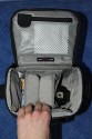 LOWEPRO - TOP LOADER ZOOM AW\n\nFoto von Peter Albrecht - VIELEN DANK!\n\nKommentar:\n\n- gekauft Januar 2009 (scheint auch berarbeitete Version zu sein gegenber dem Model, welches auch auf taschenfreak gezeigt wird)\n  neu: - Reisverschlu innen im Deckel hat jetzt eine Schutzkappe (Bild 06)\n       - SlipLock auf beiden Seiten (Bilder 02 und 04)\n\n- Beigaben:\n  - Schultergurt (Bild 05)\n  - Chest Harness (4 Kunststoffhaken) (Bild 05)\n      - Chest Harness, den man als extra Zubehr erwerben kann hat fr die oberen Ringe zwei Metallhaken\n      - Gurte lassen sich schnell und einfach verstellen\n      - keine Anleitung => erst mal experimentieren, aber man kriegs relativ schnell hin\n  - klitzekleine Anleitung fr die Tasche selbst (englisch / franzsisch / kein Deutsch)\n  - Werbeschild 30 Jahre Lowepro (ist dann wohl schon etwas lter) (Bild 01)\n\n- Innenraum mit 4 Trennern veriabel gestaltbar (Bilder 05, 07, 08 und 09)\n- beim 18-55mm Objektiv kann man problemlos das Ladegert fr die Akkus unter einem doppelten Boden verstauen (Bild 09)\n- die zwei groen Trenner haben noch seitliche Taschen fr Kleinzeugs (z.B. Akkus) (Bilder 05 und 08)\n- Zwei SlipLock Schlaufen (je eine links und rechts) (Bilder 02 und 04)\n- die oberen zwei Ringe zur Befestigung des Tragesystems sind aus Metall, die unteren aus Kunststoff, aber die sind ja nicht so wichtig.\n\n- Was geht rein?\n  - Canon 500D mit Batteriegriff und Tragegurt (Bild 06)\n  - Speedlite 430 EX II + Ersatzakkus + Zweitakku fr Camera (Bild 08)\n  - Ladegert (Bild 09)\n  - Zettel und Speicherkarte (Bild 10)\n  - Anleitungen fr Speedlite und 500D, Stifte, Taschenlampe (Bild 11)\n  - Mignon-Halter fr den Batteriegriff - aber UNGEPOLSTERT! (Bild 12)\n\n\n- All-Weather-Cover (AWC): (Bilder 13 - 16)\n  - Ringe und Gurtschlaufe fr Tragesysteme bleiben frei\n  - Deckel, Fronttasche, Seitentasche sind eingepackt (kein Zugang)\n  - SlipLock auch bei AWC verwendbar\n  - Tragsystem mu vor dem Aufziehen des AWC nicht entfernt werden\n  - Seite am Krper und die Hlfte der linken/rechten Seite (Sliplock) bleiben frei\n  - AWC ber langes Band fest mit Tasche vernht -> kein Verlieren\n\nNegativ:\n- Toploader-Deckel (geschwungen) pat zur Kamera-Form (eher flach) (Bild 17)\n- Blitznase spreitzt sich beim Einlegen an Klettverschlubasis (mit der Zeit lernt man aber, wie mans gut rein bringt)\n- Klettverschlu fr Innenraumteiler aufgenht -> sieht nicht so toll aus und man kann beim Einpacken daran hngen bleiben (EOS 500D) (Bilder 07 und 08)\n- Im Vergleich zum Toploader Pro 70 AW hat der Zoom AW eher ein Plastik-Feeling (besonders die Tasche im Deckel) (Bild 09)\n- Fronttasche garnicht gepolstert -> keine empfindlichen Sachen verstauen\n - im oberen Teil ist das AWC zwischen Tascheninhalt und auen (Bild 11)\n - unten gibts nur ein ungepolstertes Stck Stoff, den Mignon-Halter fr den Batteriegriff sollte man da NICHT transportiern (Bild 12)