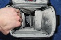 LOWEPRO - TOP LOADER ZOOM AW\n\nFoto von Peter Albrecht - VIELEN DANK!\n\nKommentar:\n\n- gekauft Januar 2009 (scheint auch berarbeitete Version zu sein gegenber dem Model, welches auch auf taschenfreak gezeigt wird)\n  neu: - Reisverschlu innen im Deckel hat jetzt eine Schutzkappe (Bild 06)\n       - SlipLock auf beiden Seiten (Bilder 02 und 04)\n\n- Beigaben:\n  - Schultergurt (Bild 05)\n  - Chest Harness (4 Kunststoffhaken) (Bild 05)\n      - Chest Harness, den man als extra Zubehr erwerben kann hat fr die oberen Ringe zwei Metallhaken\n      - Gurte lassen sich schnell und einfach verstellen\n      - keine Anleitung => erst mal experimentieren, aber man kriegs relativ schnell hin\n  - klitzekleine Anleitung fr die Tasche selbst (englisch / franzsisch / kein Deutsch)\n  - Werbeschild 30 Jahre Lowepro (ist dann wohl schon etwas lter) (Bild 01)\n\n- Innenraum mit 4 Trennern veriabel gestaltbar (Bilder 05, 07, 08 und 09)\n- beim 18-55mm Objektiv kann man problemlos das Ladegert fr die Akkus unter einem doppelten Boden verstauen (Bild 09)\n- die zwei groen Trenner haben noch seitliche Taschen fr Kleinzeugs (z.B. Akkus) (Bilder 05 und 08)\n- Zwei SlipLock Schlaufen (je eine links und rechts) (Bilder 02 und 04)\n- die oberen zwei Ringe zur Befestigung des Tragesystems sind aus Metall, die unteren aus Kunststoff, aber die sind ja nicht so wichtig.\n\n- Was geht rein?\n  - Canon 500D mit Batteriegriff und Tragegurt (Bild 06)\n  - Speedlite 430 EX II + Ersatzakkus + Zweitakku fr Camera (Bild 08)\n  - Ladegert (Bild 09)\n  - Zettel und Speicherkarte (Bild 10)\n  - Anleitungen fr Speedlite und 500D, Stifte, Taschenlampe (Bild 11)\n  - Mignon-Halter fr den Batteriegriff - aber UNGEPOLSTERT! (Bild 12)\n\n\n- All-Weather-Cover (AWC): (Bilder 13 - 16)\n  - Ringe und Gurtschlaufe fr Tragesysteme bleiben frei\n  - Deckel, Fronttasche, Seitentasche sind eingepackt (kein Zugang)\n  - SlipLock auch bei AWC verwendbar\n  - Tragsystem mu vor dem Aufziehen des AWC nicht entfernt werden\n  - Seite am Krper und die Hlfte der linken/rechten Seite (Sliplock) bleiben frei\n  - AWC ber langes Band fest mit Tasche vernht -> kein Verlieren\n\nNegativ:\n- Toploader-Deckel (geschwungen) pat zur Kamera-Form (eher flach) (Bild 17)\n- Blitznase spreitzt sich beim Einlegen an Klettverschlubasis (mit der Zeit lernt man aber, wie mans gut rein bringt)\n- Klettverschlu fr Innenraumteiler aufgenht -> sieht nicht so toll aus und man kann beim Einpacken daran hngen bleiben (EOS 500D) (Bilder 07 und 08)\n- Im Vergleich zum Toploader Pro 70 AW hat der Zoom AW eher ein Plastik-Feeling (besonders die Tasche im Deckel) (Bild 09)\n- Fronttasche garnicht gepolstert -> keine empfindlichen Sachen verstauen\n - im oberen Teil ist das AWC zwischen Tascheninhalt und auen (Bild 11)\n - unten gibts nur ein ungepolstertes Stck Stoff, den Mignon-Halter fr den Batteriegriff sollte man da NICHT transportiern (Bild 12)