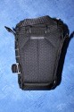 LOWEPRO TOPLOADER PRO 70 AW\n\nFoto und Text von Peter Albrecht - VIELEN DANK!\n\nKommentar:\n\n- gekauft Januar 2009 (vermutlich der Nachfolger des "Toploader 70 AW" - ohne "Pro")\n  - Unterschied zum "ohne Pro": \n     - Deckel klappt jetzt nach links weg anstatt nach vorne.\n     - hat nur noch auf einer Seite (links) Sliplock-Erweiterungsmglichkeit\n     - statt der Sliplock rechts, gibts jetzt eine Auentasche, die mit Gummi oben "gesichert" ist\n		- es gibt aber (Stand Januar 2009) auch noch den "ohne Pro" frs gleiche Geld im Internet\n\n- Beigaben:\n  - Dreipunkt Gurt zum tragen (Bild 01)\n  - klitzekleine deutsche Anleitung\n  - Werbeschild 40 Jahre Lowepro (mte der Aktuelle Stand sein)\n\n- Camera (500D) sitzt fest in der Tasche\n- Innenraum mit 2 Trennern verstellbar (Bilder 09, 10 und 11)\n- bleibt grundsttzlich sogar aufrecht stehen (ist aber nicht besonders stabil, besser hinlegen)\n- Karabiner des Schultergurtes aus Metall\n- mit ein bichen Gefummel, kann man auch die Cameratasche fr die PowerShot in der SlingShot Schlaufe einhngen (Bild 18)\n- Schnellverschlu (keine Reisverschlsse notwendig, um nur die Kamera zu halten)\n- Cameragurt kann man entweder mit in die Tasche rein packen (Bilder 07 und 08), oder raus hngen lassen und ggf in die \n Auentasche packen (Bilder 05 und 06).\n\n- Was pat rein? (Bild 16)\n  - Canon 500D mit Batteriegriff und Tragegurt (Bilder 05 und 07)\n  - Ladegert (unter doppeltem Boden) (Bild 12)\n  - Mignon-Halter fr den Batteriegriff (Bild 13)     - \n  - Speedlite 430 EX II + Zweitakku fr Camera (Bild 14)\n  - Zettel, Speicherkarte, Blitz Ersatzakkus, Anleitungen fr Speedlite und 500D  (Bild 15)\n  - Stifte (Bild 17)\n  - (PowerShot, aber ungepolster) (Bild 17)\n\n- All-Weather-Cover (AWC): (Bilder 20 bis 23)\n  - Ringe und Gurtschlaufe fr Tragesysteme bleiben frei\n  - Deckel lt sich ffnen (wrd ich bei strmenden Regen nicht machen)\n  - Fronttasche, Seitentasche sind zugepackt (kein Zugang)\n  - SlipLock und AWC sind NICHT gleichzeitig verwendbar\n  - Tragsystem mu vor dem Aufziehen des AWC entfernt werden\n  - Nur die Seite am Krper bleibt frei\n  - AWC ber langes Band fest mit Tasche vernht -> kein Verlieren\n\nNegativ:\n- Anleitung fr Schultertragegurt fehlt. (siehe http://www.lowepro-deutschland.de/videos/flvplayer/video_toploader.html)\n- nur eine Sliplock Schlaufe (linke Seite vom Krper aus gesehen)\n- beim Tragen am 3-Punkt-Gurt ist der Toploader bei den ersten Versuchen dem linken Arm im Weg. Vielleicht findet sich durch etwas experimentieren eine bessere Position.\n\nKombination mit dem "Lowepro Chest Harness" ist nicht bequem!\n- Da der Toploader-Deckel nach links aufgeht, sind die oberen Ringe frs Tragesystem sehr nah am Krper; \n Beim Tragen am Chest Harness kippt der obere Teil der Tasche dadurch nach vorne weg, da das Tragesystem keinen\n Zug zum Kper hin erzeugen kann. Dies wiederum resultiert darin, da die untere Kante der Tasche in den \n Bauch drckt, anstatt da das ganze Rckenteil der Tasche flach aufliegt. Dadurch ist das Tragen am Chest\n Harness nicht ganz so bequem. (Der "Toploader Zoom AW" z.B. schmiegt mit dem Chest Harness viel angenehmer \n an den Brustkorb)\n- Besser: Toploader mit kleinen Karabinern an einem Rucksack festmachen. (Bild 19). Vielleicht ist auch der \n "Tamrac S-500 Chest Harness System" geeignet. Auf dem Produktbild sieht es jedenfalls so aus.
