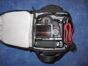 LOWEPRO TOPLOADER PRO 70 AW\n\nFoto und Text von Peter Albrecht - VIELEN DANK!\n\nKommentar:\n\n- gekauft Januar 2009 (vermutlich der Nachfolger des "Toploader 70 AW" - ohne "Pro")\n  - Unterschied zum "ohne Pro": \n     - Deckel klappt jetzt nach links weg anstatt nach vorne.\n     - hat nur noch auf einer Seite (links) Sliplock-Erweiterungsmglichkeit\n     - statt der Sliplock rechts, gibts jetzt eine Auentasche, die mit Gummi oben "gesichert" ist\n		- es gibt aber (Stand Januar 2009) auch noch den "ohne Pro" frs gleiche Geld im Internet\n\n- Beigaben:\n  - Dreipunkt Gurt zum tragen (Bild 01)\n  - klitzekleine deutsche Anleitung\n  - Werbeschild 40 Jahre Lowepro (mte der Aktuelle Stand sein)\n\n- Camera (500D) sitzt fest in der Tasche\n- Innenraum mit 2 Trennern verstellbar (Bilder 09, 10 und 11)\n- bleibt grundsttzlich sogar aufrecht stehen (ist aber nicht besonders stabil, besser hinlegen)\n- Karabiner des Schultergurtes aus Metall\n- mit ein bichen Gefummel, kann man auch die Cameratasche fr die PowerShot in der SlingShot Schlaufe einhngen (Bild 18)\n- Schnellverschlu (keine Reisverschlsse notwendig, um nur die Kamera zu halten)\n- Cameragurt kann man entweder mit in die Tasche rein packen (Bilder 07 und 08), oder raus hngen lassen und ggf in die \n Auentasche packen (Bilder 05 und 06).\n\n- Was pat rein? (Bild 16)\n  - Canon 500D mit Batteriegriff und Tragegurt (Bilder 05 und 07)\n  - Ladegert (unter doppeltem Boden) (Bild 12)\n  - Mignon-Halter fr den Batteriegriff (Bild 13)     - \n  - Speedlite 430 EX II + Zweitakku fr Camera (Bild 14)\n  - Zettel, Speicherkarte, Blitz Ersatzakkus, Anleitungen fr Speedlite und 500D  (Bild 15)\n  - Stifte (Bild 17)\n  - (PowerShot, aber ungepolster) (Bild 17)\n\n- All-Weather-Cover (AWC): (Bilder 20 bis 23)\n  - Ringe und Gurtschlaufe fr Tragesysteme bleiben frei\n  - Deckel lt sich ffnen (wrd ich bei strmenden Regen nicht machen)\n  - Fronttasche, Seitentasche sind zugepackt (kein Zugang)\n  - SlipLock und AWC sind NICHT gleichzeitig verwendbar\n  - Tragsystem mu vor dem Aufziehen des AWC entfernt werden\n  - Nur die Seite am Krper bleibt frei\n  - AWC ber langes Band fest mit Tasche vernht -> kein Verlieren\n\nNegativ:\n- Anleitung fr Schultertragegurt fehlt. (siehe http://www.lowepro-deutschland.de/videos/flvplayer/video_toploader.html)\n- nur eine Sliplock Schlaufe (linke Seite vom Krper aus gesehen)\n- beim Tragen am 3-Punkt-Gurt ist der Toploader bei den ersten Versuchen dem linken Arm im Weg. Vielleicht findet sich durch etwas experimentieren eine bessere Position.\n\nKombination mit dem "Lowepro Chest Harness" ist nicht bequem!\n- Da der Toploader-Deckel nach links aufgeht, sind die oberen Ringe frs Tragesystem sehr nah am Krper; \n Beim Tragen am Chest Harness kippt der obere Teil der Tasche dadurch nach vorne weg, da das Tragesystem keinen\n Zug zum Kper hin erzeugen kann. Dies wiederum resultiert darin, da die untere Kante der Tasche in den \n Bauch drckt, anstatt da das ganze Rckenteil der Tasche flach aufliegt. Dadurch ist das Tragen am Chest\n Harness nicht ganz so bequem. (Der "Toploader Zoom AW" z.B. schmiegt mit dem Chest Harness viel angenehmer \n an den Brustkorb)\n- Besser: Toploader mit kleinen Karabinern an einem Rucksack festmachen. (Bild 19). Vielleicht ist auch der \n "Tamrac S-500 Chest Harness System" geeignet. Auf dem Produktbild sieht es jedenfalls so aus.