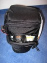LOWEPRO TOPLOADER PRO 70 AW\n\nFoto und Text von Peter Albrecht - VIELEN DANK!\n\nKommentar:\n\n- gekauft Januar 2009 (vermutlich der Nachfolger des "Toploader 70 AW" - ohne "Pro")\n  - Unterschied zum "ohne Pro": \n     - Deckel klappt jetzt nach links weg anstatt nach vorne.\n     - hat nur noch auf einer Seite (links) Sliplock-Erweiterungsmglichkeit\n     - statt der Sliplock rechts, gibts jetzt eine Auentasche, die mit Gummi oben "gesichert" ist\n		- es gibt aber (Stand Januar 2009) auch noch den "ohne Pro" frs gleiche Geld im Internet\n\n- Beigaben:\n  - Dreipunkt Gurt zum tragen (Bild 01)\n  - klitzekleine deutsche Anleitung\n  - Werbeschild 40 Jahre Lowepro (mte der Aktuelle Stand sein)\n\n- Camera (500D) sitzt fest in der Tasche\n- Innenraum mit 2 Trennern verstellbar (Bilder 09, 10 und 11)\n- bleibt grundsttzlich sogar aufrecht stehen (ist aber nicht besonders stabil, besser hinlegen)\n- Karabiner des Schultergurtes aus Metall\n- mit ein bichen Gefummel, kann man auch die Cameratasche fr die PowerShot in der SlingShot Schlaufe einhngen (Bild 18)\n- Schnellverschlu (keine Reisverschlsse notwendig, um nur die Kamera zu halten)\n- Cameragurt kann man entweder mit in die Tasche rein packen (Bilder 07 und 08), oder raus hngen lassen und ggf in die \n Auentasche packen (Bilder 05 und 06).\n\n- Was pat rein? (Bild 16)\n  - Canon 500D mit Batteriegriff und Tragegurt (Bilder 05 und 07)\n  - Ladegert (unter doppeltem Boden) (Bild 12)\n  - Mignon-Halter fr den Batteriegriff (Bild 13)     - \n  - Speedlite 430 EX II + Zweitakku fr Camera (Bild 14)\n  - Zettel, Speicherkarte, Blitz Ersatzakkus, Anleitungen fr Speedlite und 500D  (Bild 15)\n  - Stifte (Bild 17)\n  - (PowerShot, aber ungepolster) (Bild 17)\n\n- All-Weather-Cover (AWC): (Bilder 20 bis 23)\n  - Ringe und Gurtschlaufe fr Tragesysteme bleiben frei\n  - Deckel lt sich ffnen (wrd ich bei strmenden Regen nicht machen)\n  - Fronttasche, Seitentasche sind zugepackt (kein Zugang)\n  - SlipLock und AWC sind NICHT gleichzeitig verwendbar\n  - Tragsystem mu vor dem Aufziehen des AWC entfernt werden\n  - Nur die Seite am Krper bleibt frei\n  - AWC ber langes Band fest mit Tasche vernht -> kein Verlieren\n\nNegativ:\n- Anleitung fr Schultertragegurt fehlt. (siehe http://www.lowepro-deutschland.de/videos/flvplayer/video_toploader.html)\n- nur eine Sliplock Schlaufe (linke Seite vom Krper aus gesehen)\n- beim Tragen am 3-Punkt-Gurt ist der Toploader bei den ersten Versuchen dem linken Arm im Weg. Vielleicht findet sich durch etwas experimentieren eine bessere Position.\n\nKombination mit dem "Lowepro Chest Harness" ist nicht bequem!\n- Da der Toploader-Deckel nach links aufgeht, sind die oberen Ringe frs Tragesystem sehr nah am Krper; \n Beim Tragen am Chest Harness kippt der obere Teil der Tasche dadurch nach vorne weg, da das Tragesystem keinen\n Zug zum Kper hin erzeugen kann. Dies wiederum resultiert darin, da die untere Kante der Tasche in den \n Bauch drckt, anstatt da das ganze Rckenteil der Tasche flach aufliegt. Dadurch ist das Tragen am Chest\n Harness nicht ganz so bequem. (Der "Toploader Zoom AW" z.B. schmiegt mit dem Chest Harness viel angenehmer \n an den Brustkorb)\n- Besser: Toploader mit kleinen Karabinern an einem Rucksack festmachen. (Bild 19). Vielleicht ist auch der \n "Tamrac S-500 Chest Harness System" geeignet. Auf dem Produktbild sieht es jedenfalls so aus.