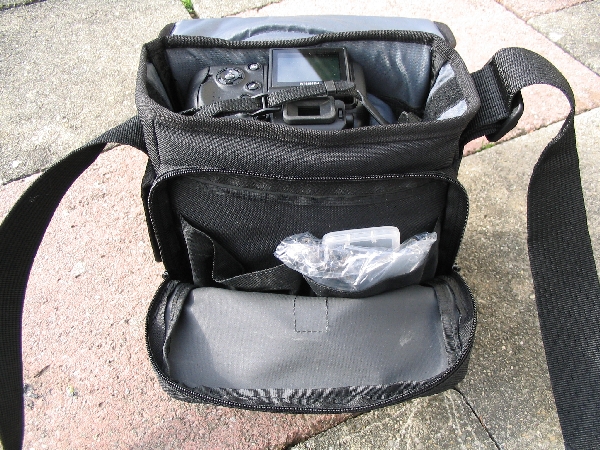 TAMRAC 5533- ADVENTURE MESSENGER 3\n\nFoto von Udo Boesch - Vielen Dank!\n\nKommentar des Nutzers:\n\nHallo Jrg Langer,\n \nich habe ein paar Bilder von einer Tamrac Adventure Messenger 3 Tasche. Es wrde mich sehr freuen, wenn du sie bei dir in deiner Page aufnehmen wrdest.\n \nHier ein paar Infos dazu:\n \nDie Tamrac-Adventure-Messenger-3 Fototasche bietet laut Hersteller Platz fr eine Spiegelreflex mit aufgesetztem Objektiv bis zu 12,5cm Lnge. Ich besitze eine Bridgekamera Fuji S9600, diese passt wirklich prima hinein. Das Hauptfach selbst ist mit 2 verstellbaren, schaumstoffgepolsterten Unterteilungen ausgestattet. Diese knnen mit Klettverschlssen individuell angepasst werden, so passt wirklich jede Kamera, egal wie breit in die Tasche. Selbstverstndlich knnen auch links und rechts Zusatzblitz oder zustzliche Objektive verstaut werden. Die Tasche bietet den Vorteil, dass hier kleine mit Klettverschluss bestckten schaumstoffgepolsterten Zwischenbden eingebracht werden knnen. So liegt das Objektiv geschtzt auf diesem Zwischenteil auf.\n \nDie Vortasche wird mit Reissverschlssen gesichert und beinhaltet 2 Einsteckfcher. Im Deckel befindet sich ein reissverschlussgesichertes flaches Einsteckfach.\nSeitlich (li + re) sind aufgesetzte Taschen, einmal mit Klettverschluss fr Handy o., auf der anderen Seite ohne Klettverschluss.\nAn der Rckwand ist ebenfalls eine aufgesetzte Tasche mit Reissverschluss, ideal fr eine Bedienungsanleitung o..\nDer Umhngegurt ist schn breit und mit einem rutschsicherem Schulterpolster versehen. Desweiteren hat die Tasche einen EasyGrip Tragegriff. \n \nDie Mae der Tasche lt. Hersteller:\nAuenmae: 23 x 23 x 14 cm (BxHxT)\nInnenmae: 20 x 20 x 10 cm (BxHxT) \nGewicht: 630 g\n \nHinweis: Alle Reissverschlsse sind regengeschtzt.\n \nFolgen Farben sind mglich: Camouflage, rot/schwarz und grau/schwarz.\n \nPreis: 39,90 \n \n \nInfos zu den einzelnen Bildern.\n \nBild 1: Frontansicht der Tasche (Camouflage) mit Tragegurt\nBild 2: Rckansicht der Tasche mit Reissverschlussfach fr Bedienungsanleiung\nBild 3: Seitenansicht mit Handyfach\nBild 4: Innenfach mit Kamera darin\nBild 5: Vortasche mit den zwei Einsteckfchern.\nBild 6: Vortasche mit den zwei Einsteckfchern\nBild 7: Hauptfach mit den zwei verstellbaren, schaumstoffgepolsterten Unterteilungen\nBild 8: Unterteilungen mit Klettverschluss verstell- und individuell anpassbar.\nBild 9: Hauptfach mit Kamera darin.\nBild 10: Tasche Frontansicht mit Verschluss\nBild 11: Gepolsterter rutschsicherer Tragegurt mit Polster (Innenseite)\nBild12: Gepolsterter rutschsicherer Tragegurt mit Polster (Aussenseite)