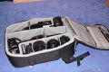 THINK TANK PHOTO - AIRPORT ULTRALIGHT\n\nFoto von Jrg Langer - www.taschenfreak.de\n\nKommentar des Nutzers:\n\nDer Airport Ultralight, ist der kleinste Rucksack der Airport Serie von Think Tank Photo. Dennoch ist auch er ein kleines Packwunder. Von den Auenmaen ist er mit einem Lowepro Mini Trecker durchaus vergleichbar (ggf. etwas hher).\n\nEs passen in unserem Beispiel bequem hinein:\n5D mit 24-70 2,8 mit Geli richtig aufgesetzt\n30D mit 100-400L IS\n70-200 4.0 mit Stativschelle\n17-40\n50 1,4\n100 2,8\nTelekonverter\n580er Blitz\nSpeicherkarten Etui\nkl. Akku Tasche fr 3x BP511\nkl. Akku Tasche fr 8x AA Zellen fr Blitz\nPanoschiene von RRS\nRRS L-Winkel an beiden Bodys\nTimer Fernbedienung\nund vorne in das Frontfach ganz bequem unser 12" Notebook/Tablet PC im Sleeve.\n\nDas Gewicht ist super bequem (deutlich bequemer als beim Mini oder Compu Trekker) auf den Schultern verteilt, obwohl die Schultergurte so leicht und schwach wirken auf den ersten Blick. Da steckt gekonnte Think Tank Entwicklung dahinter.\n\nGeliefert wird der Ultralight mit abhehmbaren Beckengurt und einem Regencover das auch auf einigen Bildern zu sehen ist.\n\nEinziges fr uns erkennbares Manko ist das dieser Think Tank Rucksack keine Stativhalterung hat (die wir eh nicht nutzen, aber viele - warum auch immer - diese gerne nutzen mchten). Wir tragen unser Stativ an einem langen Umhngegurt wie eine Flinte unter dem Arm und der Umhngegurt ist auch bequem in Verbindung mit einem Rucksack zu nutzen.\n\nWer seinen Ultralight besonders schtzen mchte kann diesen gerade so passend (etwas drcken muss man aber ..) in einem PeliCase 1510 Trolly Koffer reinpacken und damit hinter sich herziehen. Ein Notebook darf dann aber nicht in der Frontasche des Notebooks legenund zu eng sollte es im Rucksack auch nicht "zugehen", damit man das Peli Case noch anstndig und wasserdicht verschlieen kann.\n\nEr ist jeden Cent den er teurer als ein vergleichbarer Rucksack anderer Hersteller ist wert, aber das kann man nicht auf Fotos "rberbringen", aber dieses werden Ihnen viele zufriedenen Think Tank Kunden besttigen.\n\nWie immer bei den Think Tank Produkten bekommt auch dieser unser Prdikat "BESONDERS EMPFEHLENSWERT".
